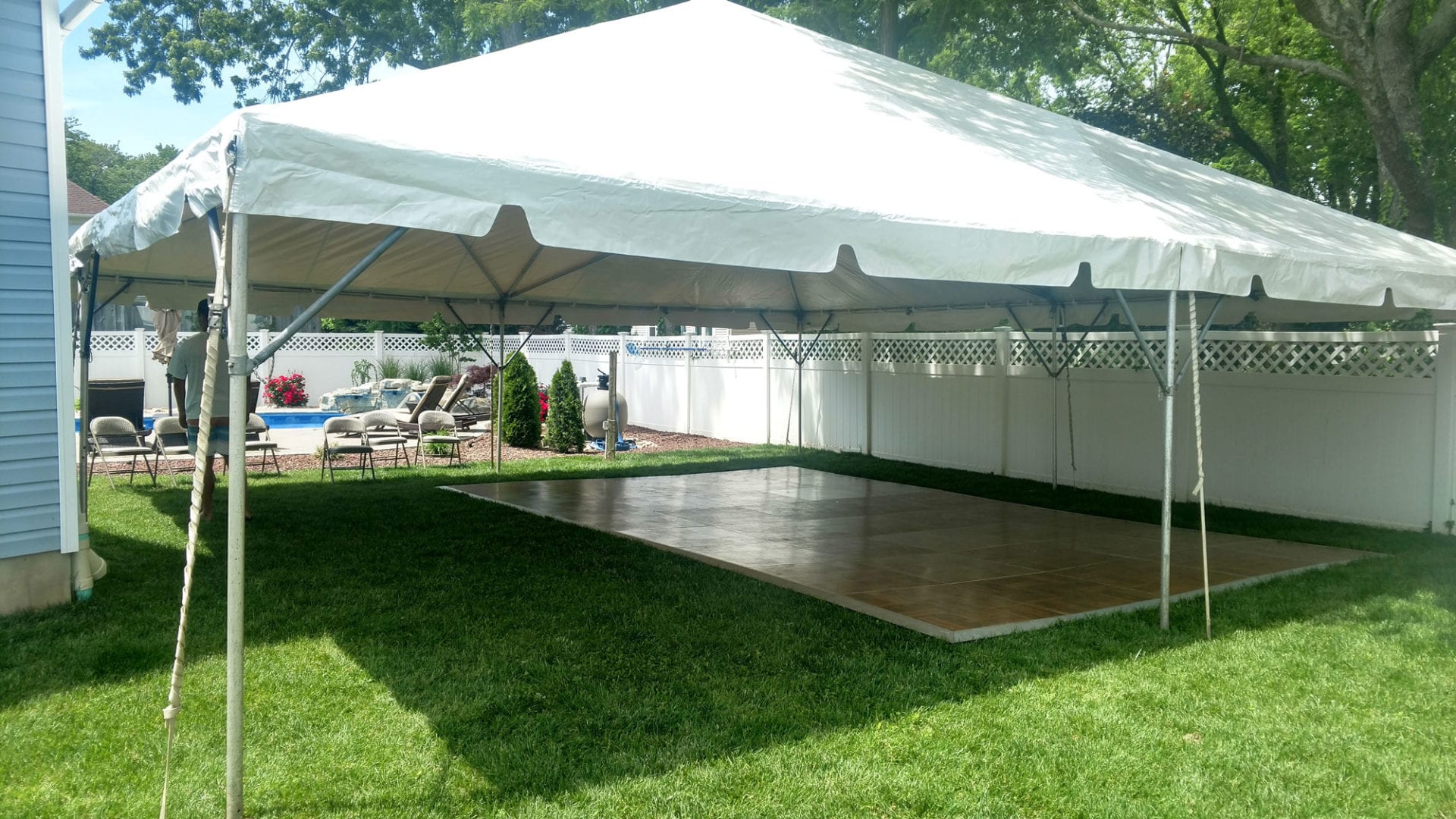 A white tent with wood floor