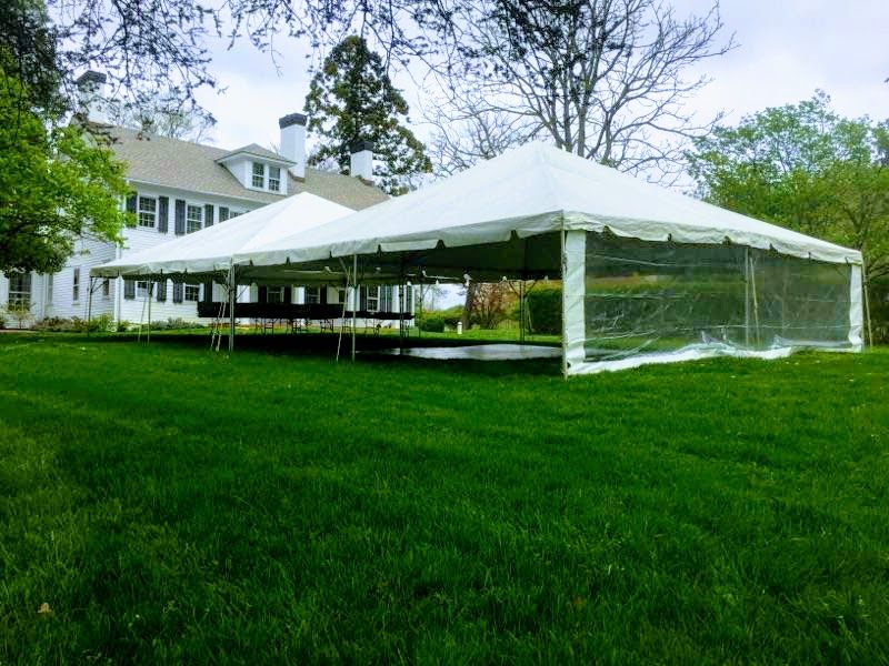A white tent near a white house