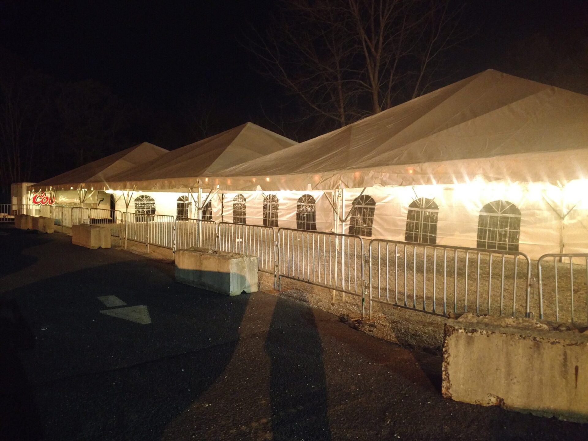 Three white tents with lights
